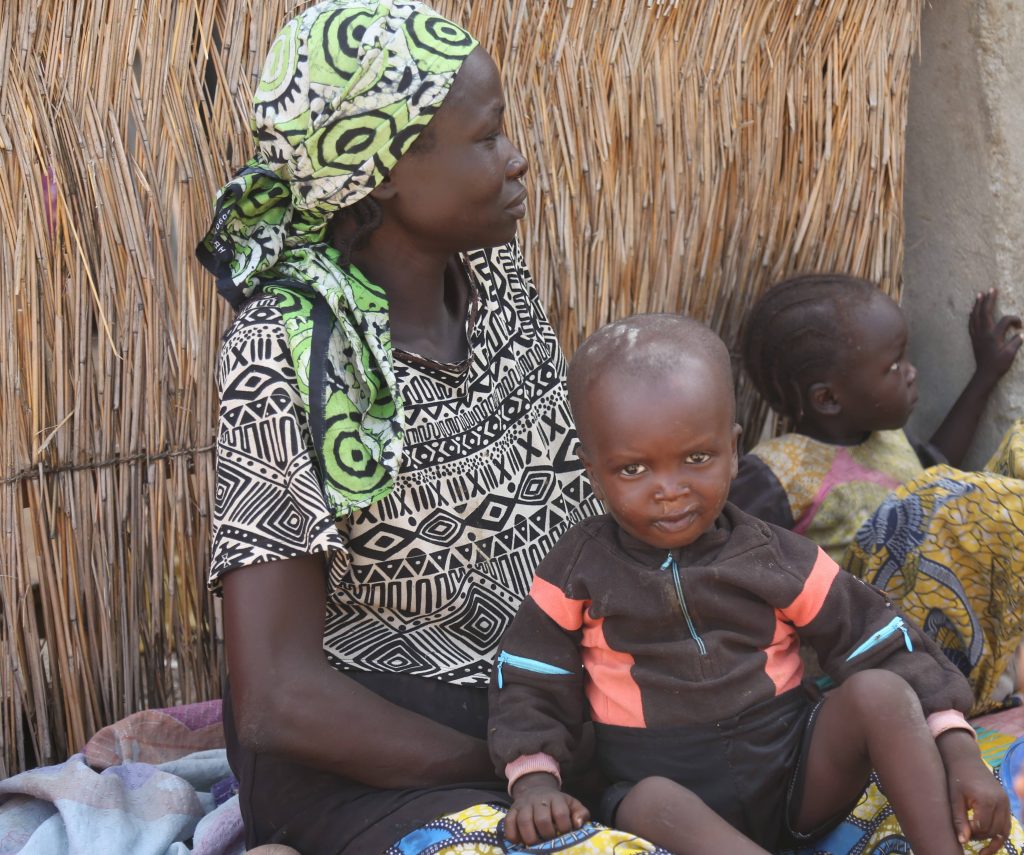 Hasana Mouda forgoes her farming activities of the day to ensure her two zero-dose children receive life-saving vaccines.